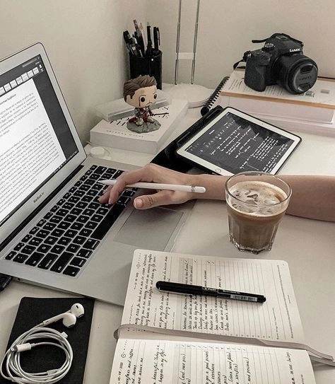 Laptop, tablet, notebook, and coffee on a workspace desk illustrating digital marketing strategies by a freelance digital marketer in Saudi Arabia.